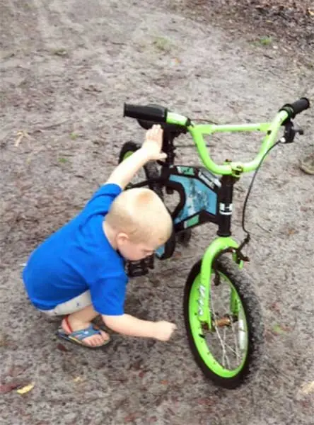 Lake Area Bikes - young man working on  his bicycle